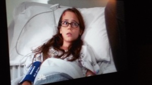 Zoe hesitantly answers the detectives' questions in the hospital